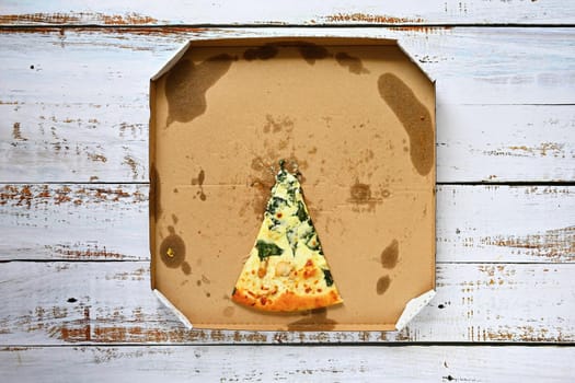 Delicious fresh pizza in a box on a wooden background. Concept for food - fast food - home delivery.