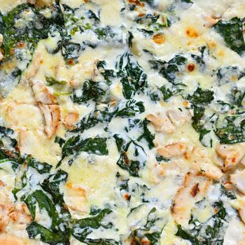 Close-up photos of food. Delicious fresh pizza with cream and spinach.