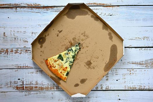 Delicious fresh pizza in a box on a wooden background. Concept for food - fast food - home delivery.