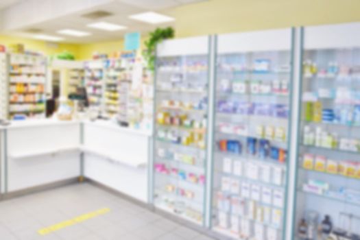 Blurred background. Interior of a pharmacy with goods and showcases. Medicines and vitamins for health. Shop concept, medicine and healthy lifestyle