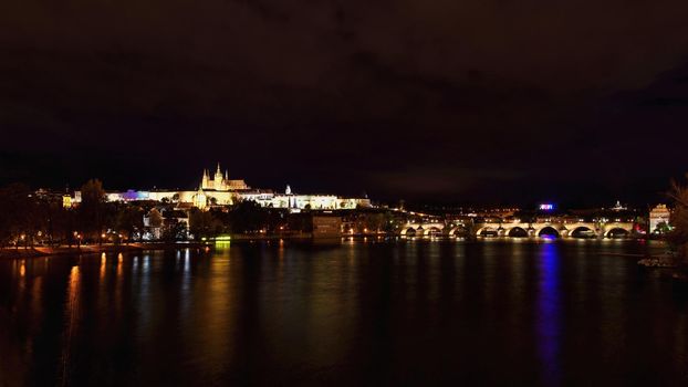 A panoramic view Prague Castle, the Charles Bridge and the Vltava River in the beautiful city of Prague, Czech Republic - Europe. A beautiful night photo of the architecture of the capital.