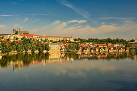 Prague, capital of the Czech Republic. Scenic sunset view of the Old Town pier architecture and Charles Bridge over Vltava river. 