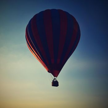 Colorful hot air balloon is flying at sunset. Natural colorful background with sky.
