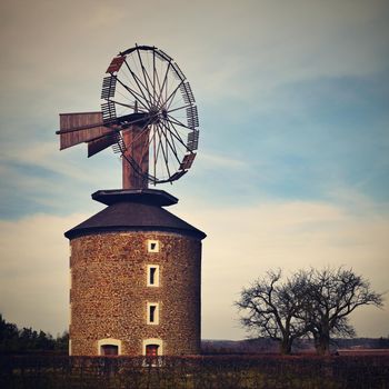 Beautiful old windmill at sunset with sky and clouds. Ruprechtov - Czech Republic - Europe.