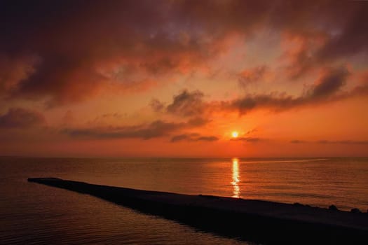 Beautiful sunrise-sunset by the sea at the beach. Romantic landscape, concept for summer.