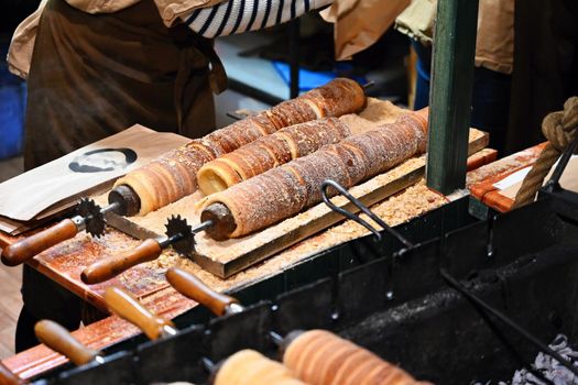 Close up of cooking the traditional sweet Czech pastry, trdelnik-trdlo.