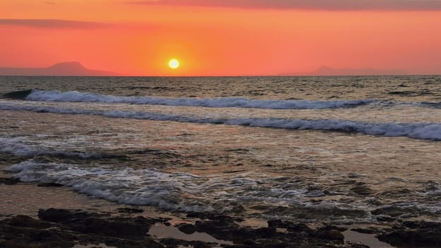 Beautiful sunset at the beach with the sea in the background. Landscape for summer holidays.