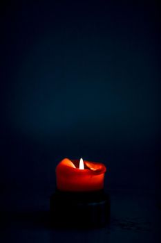 Happy holidays, greeting card backdrop and winter season concept - Red holiday candle on dark background, luxury branding design and decoration for Christmas, New Years Eve and Valentines Day