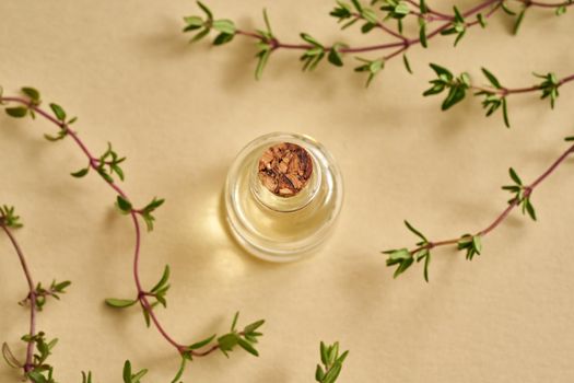 Essential oil bottle with fresh thyme twigs