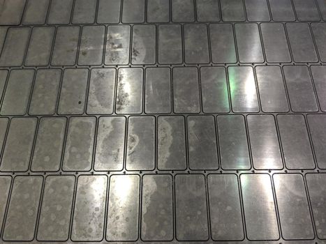 full frame background of waterjet cutted parts in steel sheet.