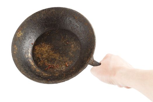 bare caucasian hand holding empty old cast iron frying pan - isolated on white background