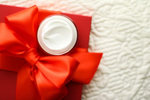 Beauty, cosmetics and skincare styled concept - Luxury face cream jar and a red gift box