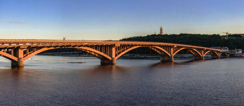 Kyiv, Ukraine 07.11.2020. Kyiv Metro bridge across the Dnieper river on a sunny summer evening.