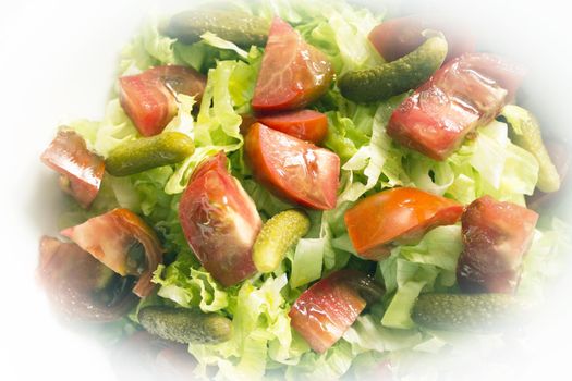 Lettuce salad with tomato and pickles. Raw food