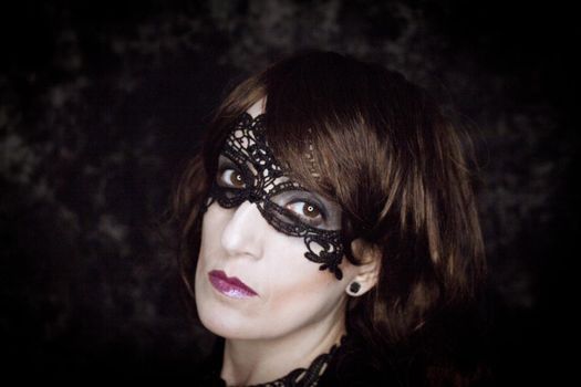 Woman disguised in gothic style for halloween party with mask