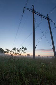 Landscape with Electricity poles fog and sunset
