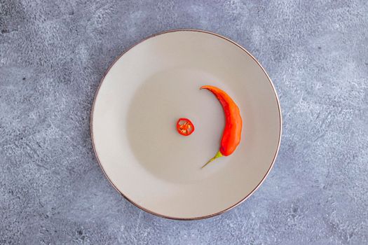 Presentation of the Peruvian red hot chili (Ají Limo) in a colored plate