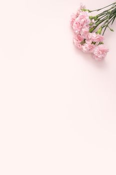 Design concept of Mother's day holiday greeting design with carnation bouquet on pastel pink table background