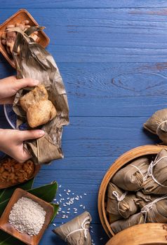 Zongzi rice dumpling with ingredients top view for Chinese traditional Dragon Boat Festival (Duanwu Festival) over blue wooden table background.