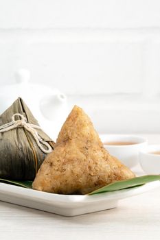 Zongzi. Rice dumpling for Chinese traditional Dragon Boat Festival (Duanwu Festival)  on bright wooden table background.