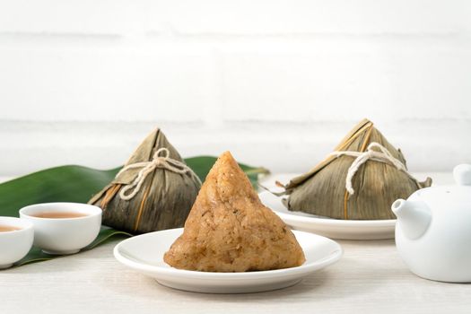 Zongzi. Rice dumpling for Chinese traditional Dragon Boat Festival (Duanwu Festival)  on bright wooden table background.