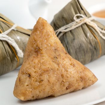 Zongzi. Rice dumpling for Chinese traditional Dragon Boat Festival (Duanwu Festival)  on bright wooden table background.