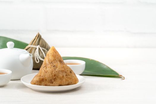 Zongzi. Rice dumpling for Chinese traditional Dragon Boat Festival (Duanwu Festival)  on bright wooden table background.