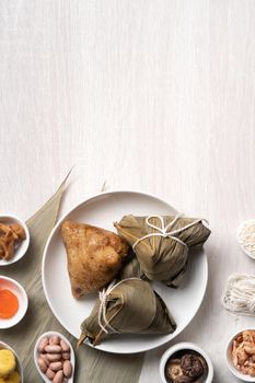 Zongzi. Delicious traditional rice dumpling food for Dragon Boat Duanwu Festival over wooden table background top view.