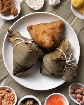 Zongzi. Delicious traditional rice dumpling food for Dragon Boat Duanwu Festival over wooden table background top view.