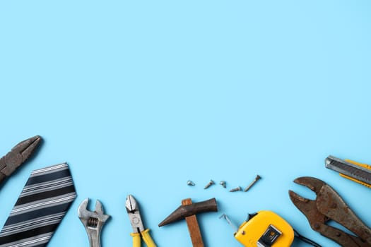 Father's Day design concept. Top view of Father's and labor day with working tools on blue background.