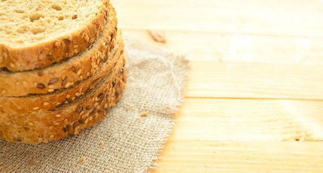 Several slices of cereal bread on a wooden background,copyspace.