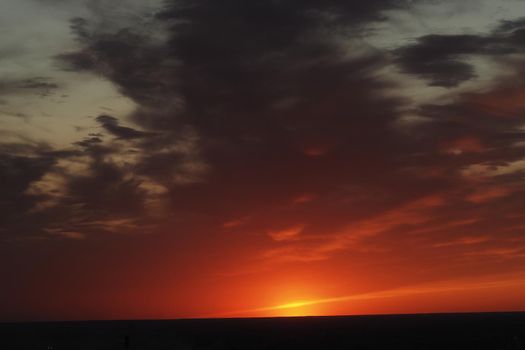 It's a beautiful sunset. Night sky with clouds and the setting sun on the horizon. High quality photo