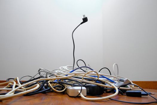 A tangled tangle of unnecessary wires lies on the floor.