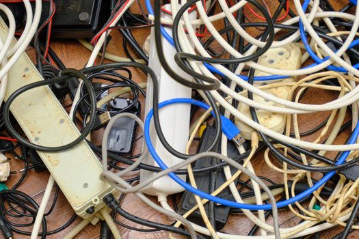 A tangled tangle of unnecessary wires lies on the floor.