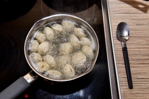 Russian Dumplings in boiling water. Meat dumplings are boiled in a pot of boiling water.