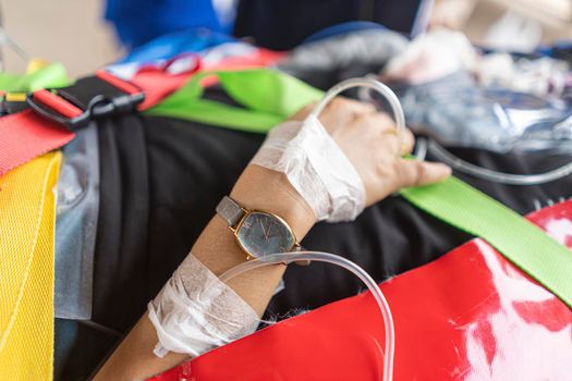 A close-up picture of a patient hand taking saline solution