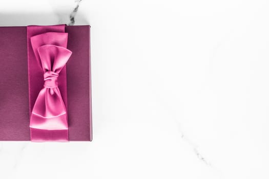 Birthday, wedding and girly branding concept - Pink gift box with silk bow on marble background, girl baby shower present and glamour fashion gift for luxury beauty brand, holiday flatlay art design