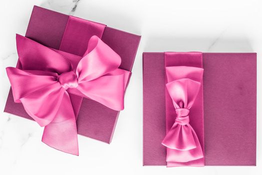 Birthday, wedding and girly branding concept - Pink gift box with silk bow on marble background, girl baby shower present and glamour fashion gift for luxury beauty brand, holiday flatlay art design