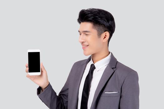 Portrait young asian business man showing and presenting smartphone with blank with success isolated on white background, businessman standing and holding phone, communication concept.