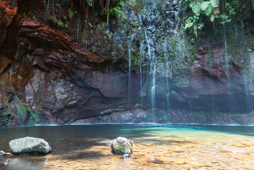 famous location of 25 waterfalls at Madeira Island by bright sunny day