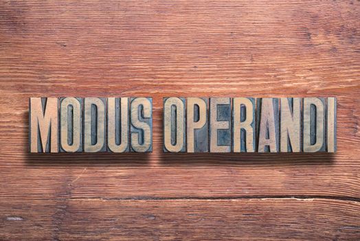 modus operandi ancient Latin saying meaning - way of working, combined on vintage varnished wooden surface
