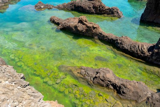 shallow sea water pond in natural rocks from Porto-Moniz, Portugal