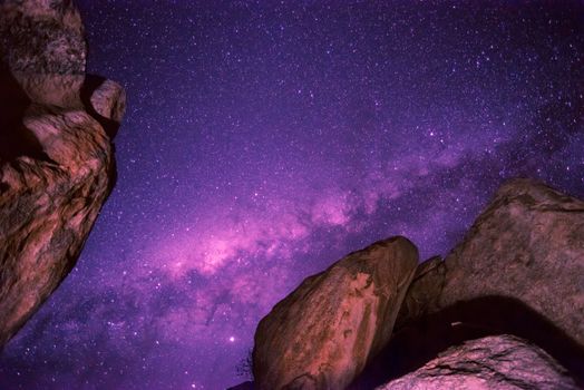 starry night sky with Milky Way above huge rocks in Namibia