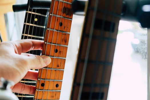 close up Image of Hand picking up guitar