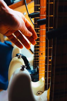 close up Image of Hand picking up guitar