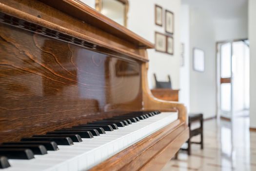 Wood grand-piano with a defocused background