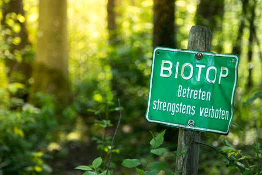 Nature reserve area in Germany. Sign with “Biotop. Betreten strengstens verboten”.