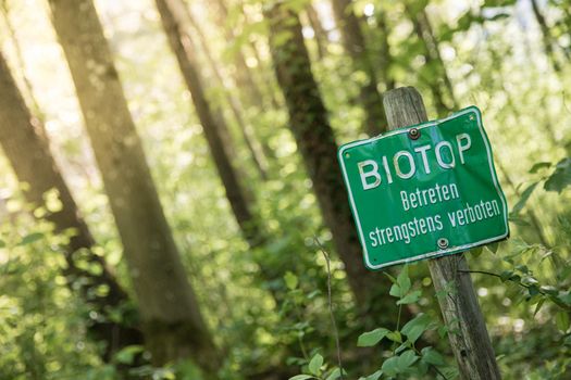 Nature reserve area in Germany. Sign with “Biotop. Betreten strengstens verboten”.