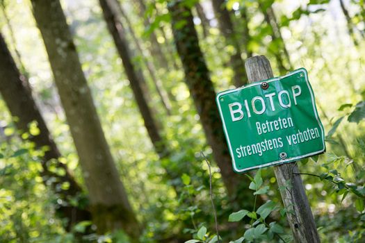 Nature reserve area in Germany. Sign with “Biotop. Betreten strengstens verboten”.