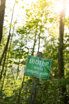 Nature reserve area in Germany. Sign with “Biotop. Betreten strengstens verboten”.